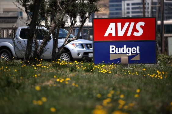 A sign is posted in front of an Avis Budget rental car office on July 28, 2020 in South San Francisco, California.