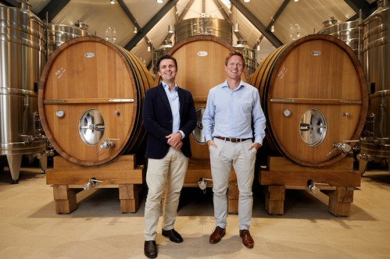 Ferovinum founders in front of 3 large wine casks