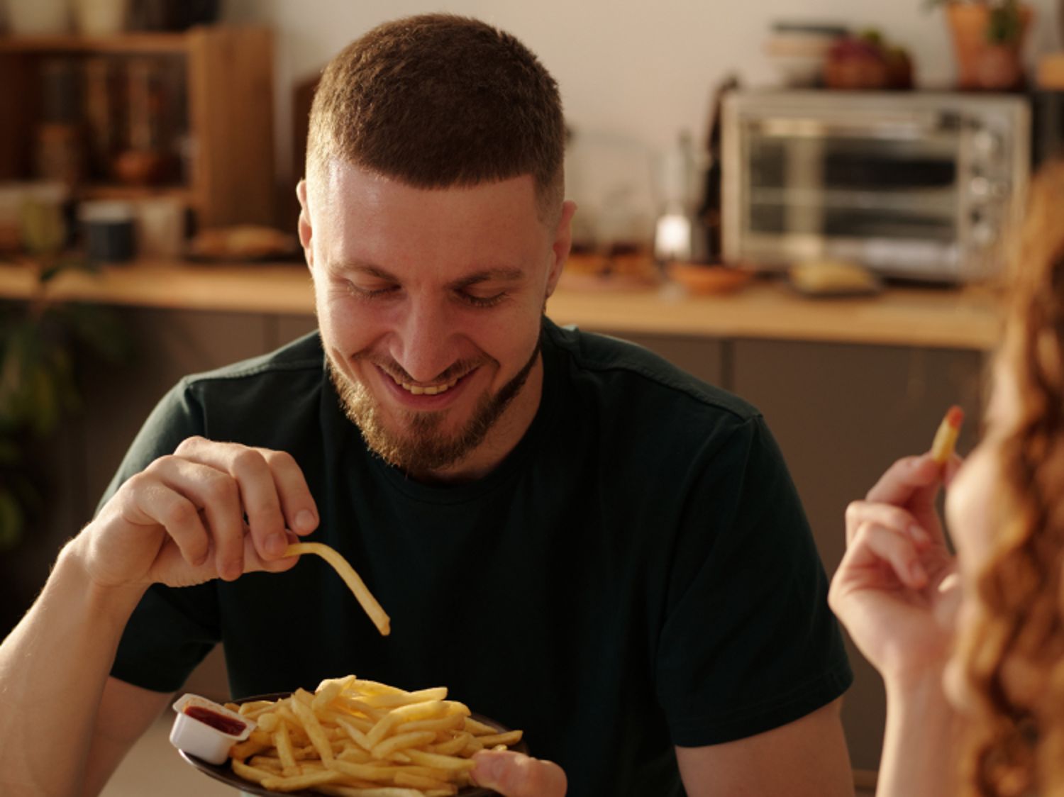 Image shows a person eating McDonald's fries