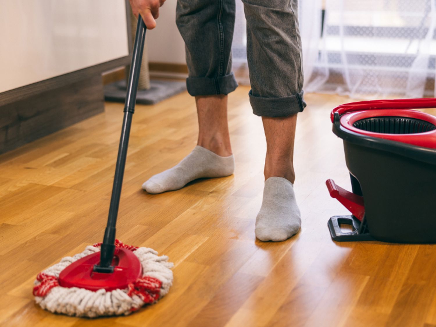 Person mopping a wood floor