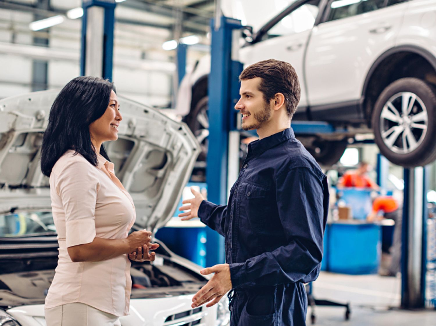 Two people engaging in a conversation in an auto repair shop
