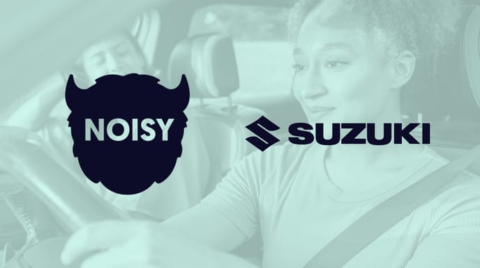 Green image of two people driving in a car with Noisy and Suzuki logos over