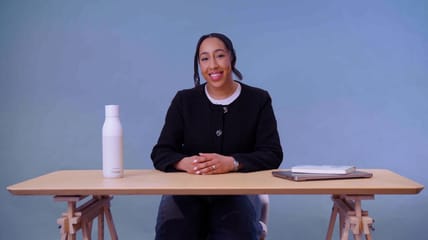 Woman sitting and smiling at a desk