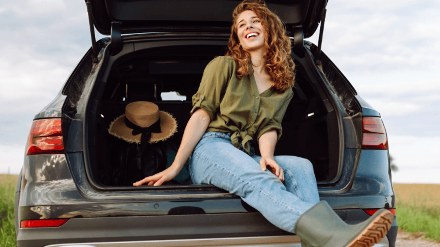 Woman sitting in Rear Hatch of SUV