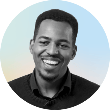 Portrait of a smiling man with a gradient background.