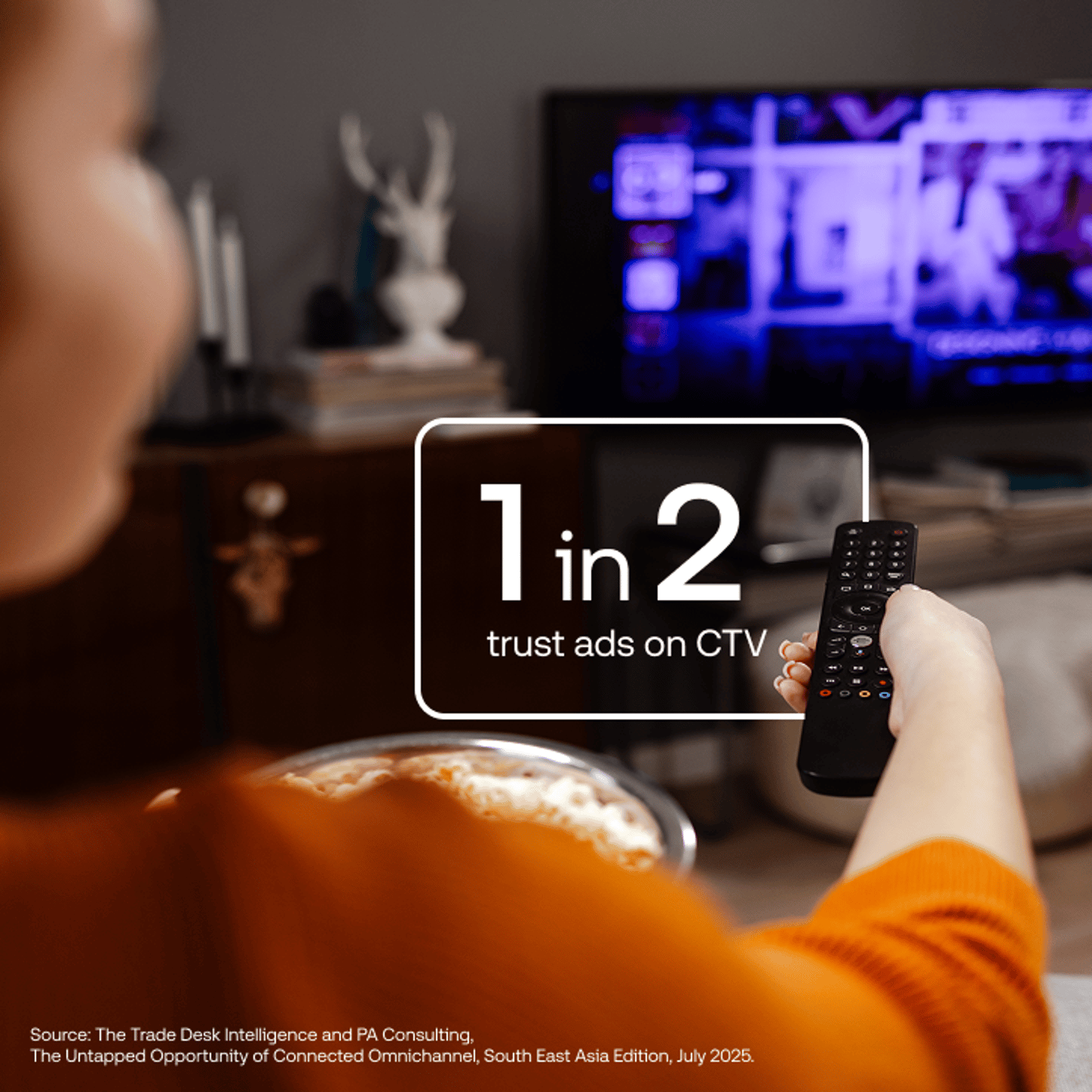 Data vis with a person watching tv in the background and a stat in white text over top